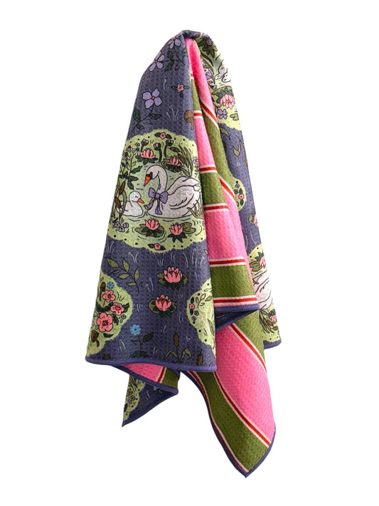 Colorful towel with floral and swan design on a white background