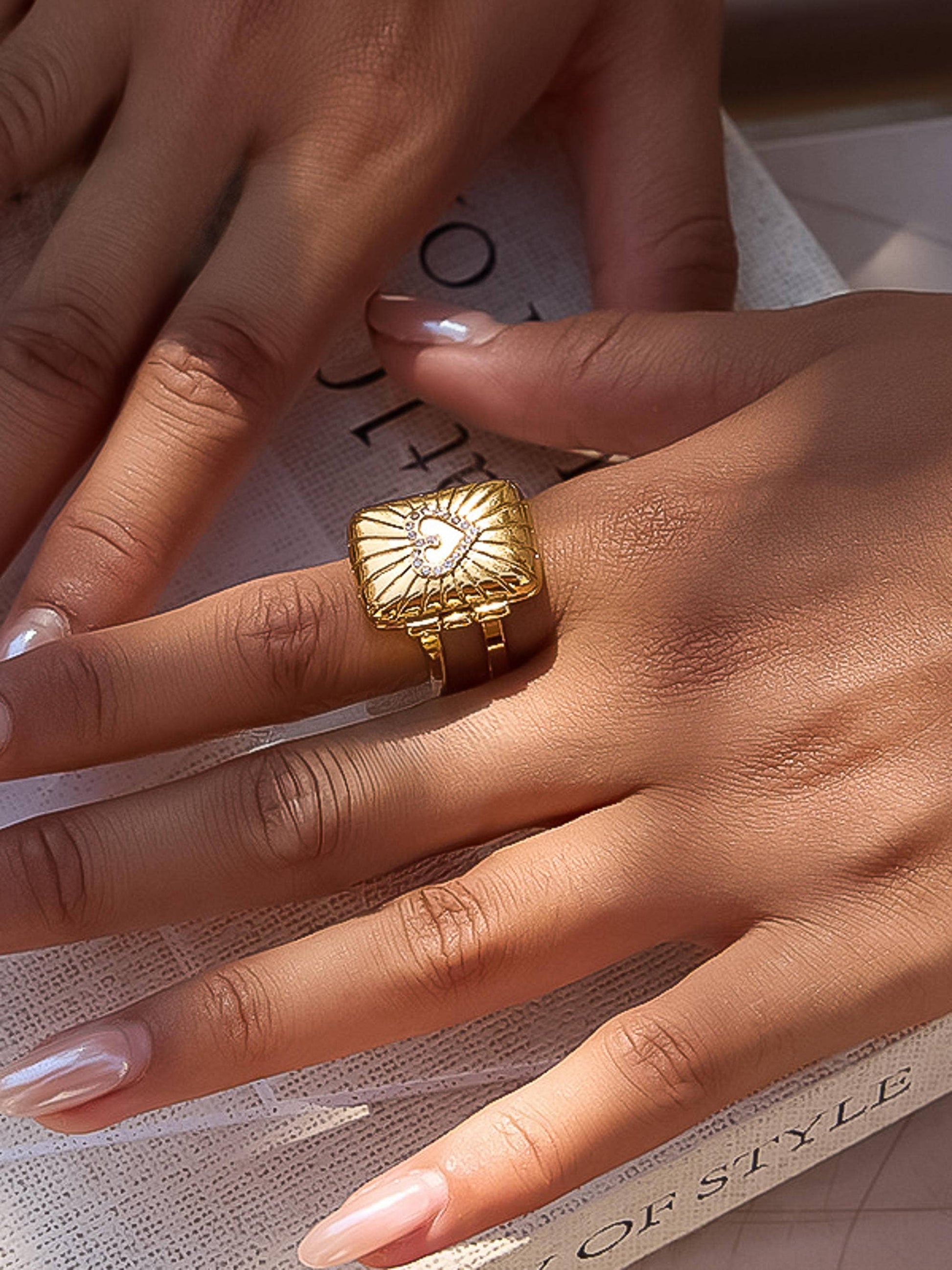 Gold ring on a hand with a blurred background