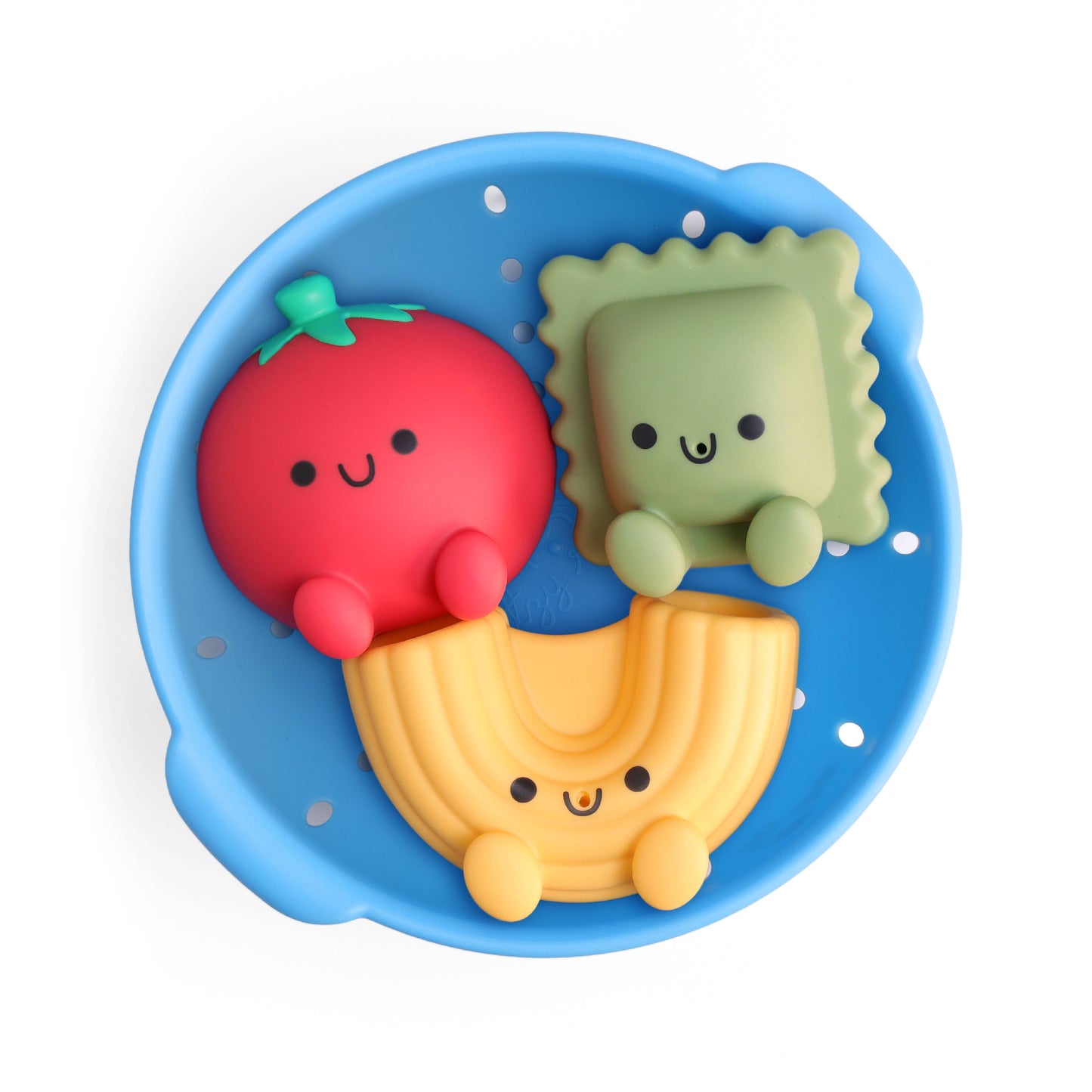 Set of 3 bath toys shaped like a tomato, ravioli, and macaroni noodle in a blue toy colander on a white background