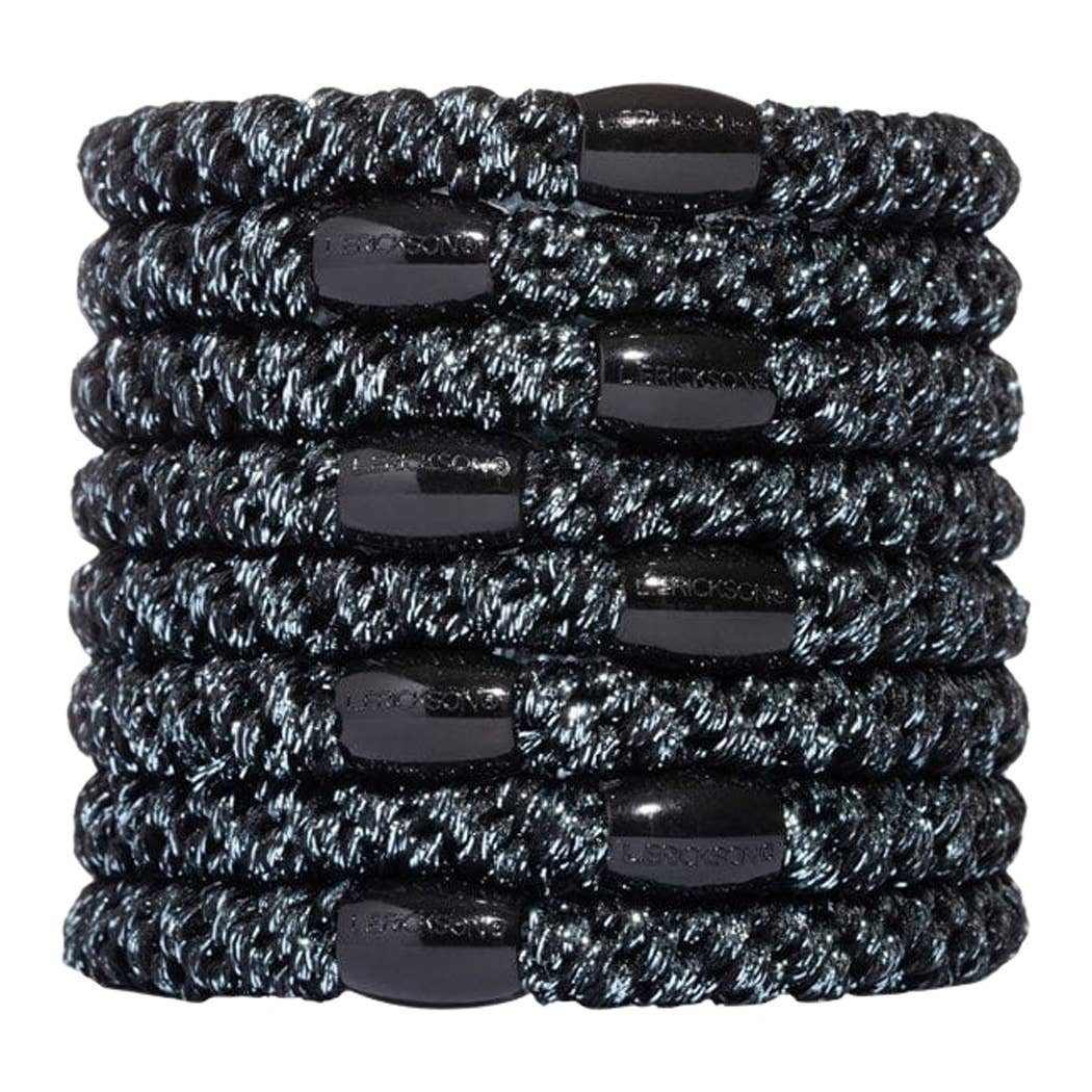 Stack of black and gray braided hair ties on a white background