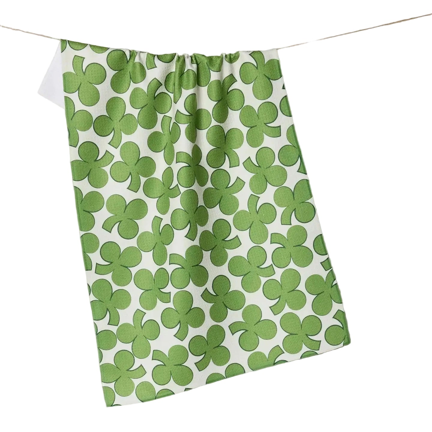 Green shamrock patterned towel hanging on a line against a beige background