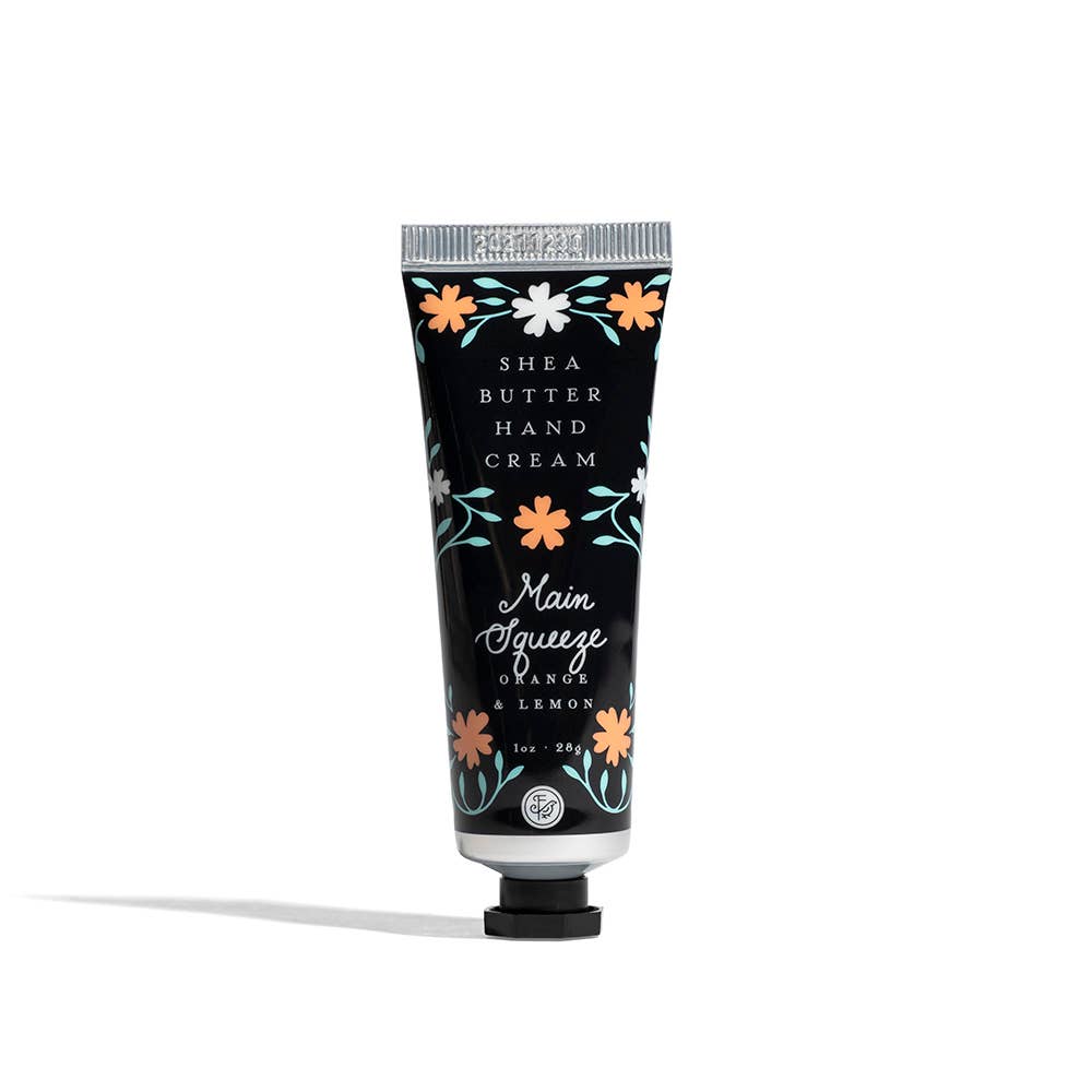Shea butter hand cream tube with floral design on a white background