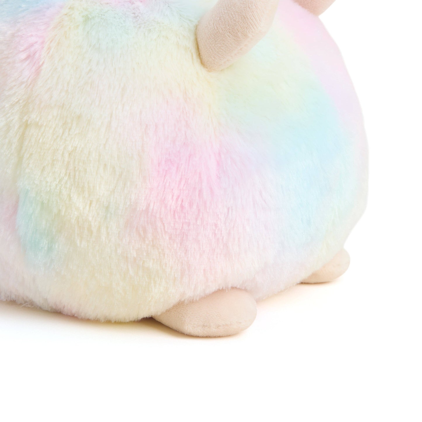 Close-up of a plush toy with rainbow-colored fur on a white background