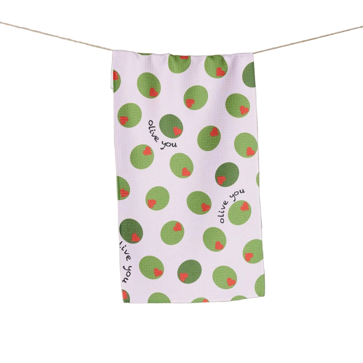 White tea towel with green olives with red heart pimentos pattern and text that reads "Olive You" on a white background
