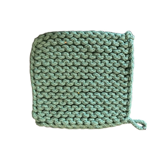 A square green crochet potholder with a small hanging loop, laid flat on a white background