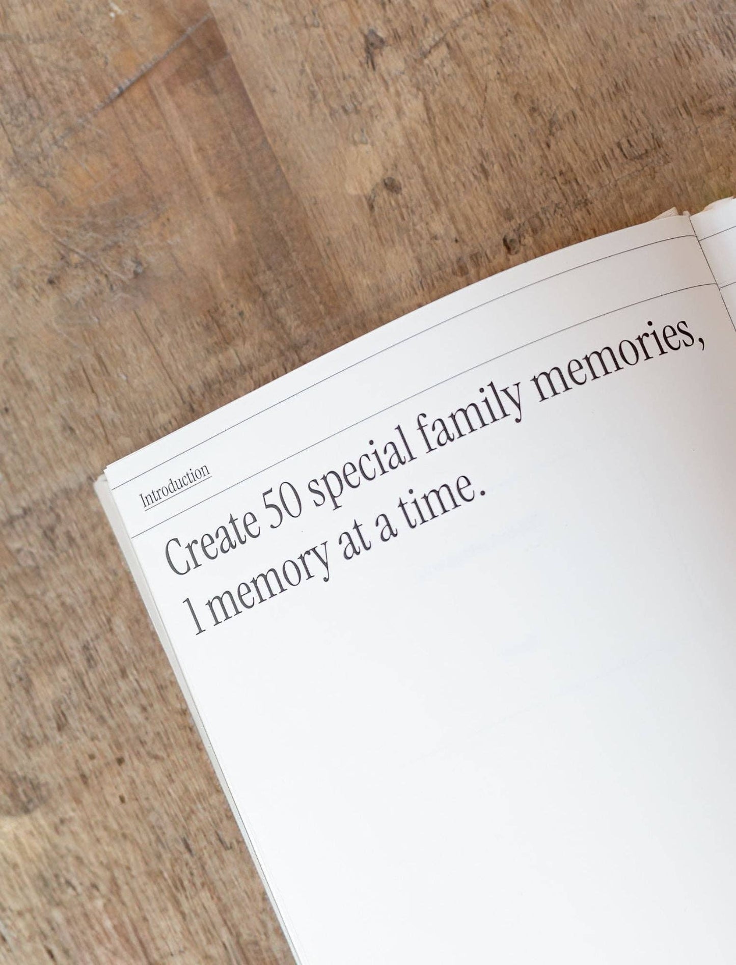 Book open to a page with text on a wooden surface