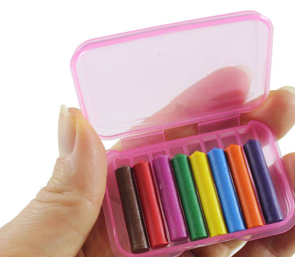 Hand holding a small pink container with 8 different small crayons inside in colors brown, red, orange, yellow, green, light blue, purple and pink