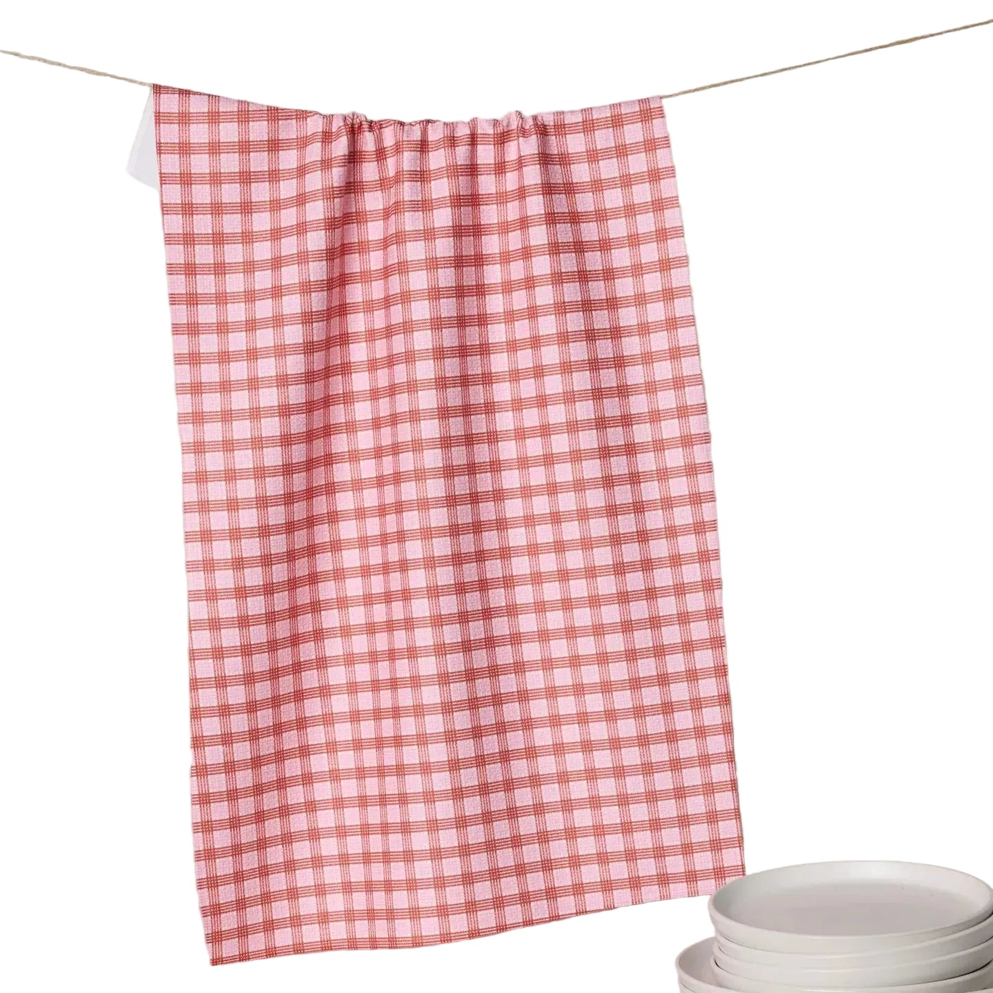 Red and white checkered towel hanging on a line with plates below.
