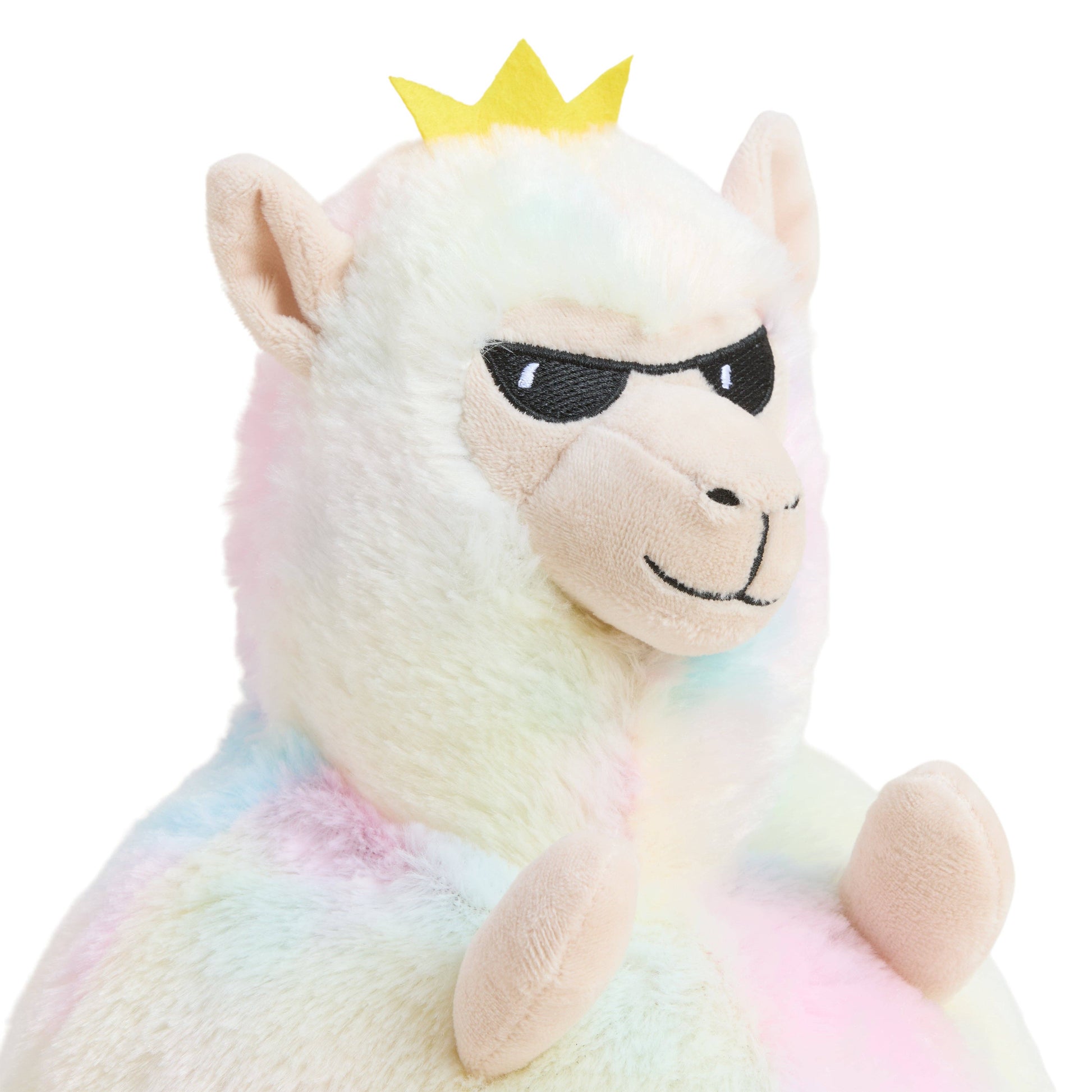 Plush toy llama with rainbow pattern, sunglasses, and yellow crown on a white background