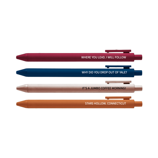 Four pens with humorous text on a brown background with star patterns