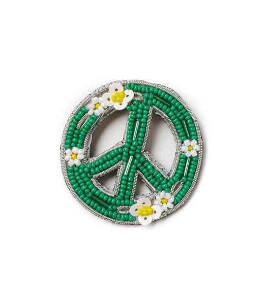 Green beaded peace symbol with white flowers on a white background