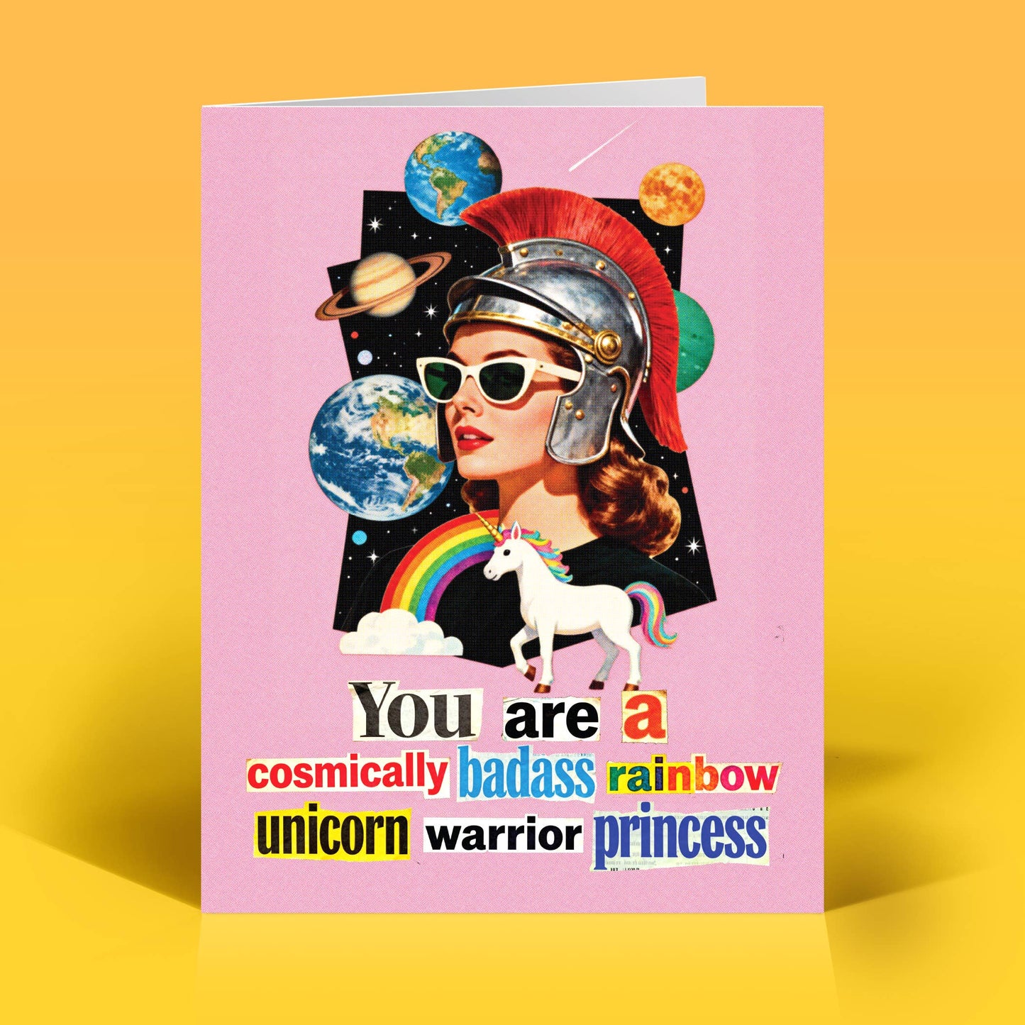 Card with a collage-style design of a woman in a warrior helmet with a unicorn, and planets on a pink background with texts that reads "You are a cosmically badass rainbow unicorn, warrior princess"
