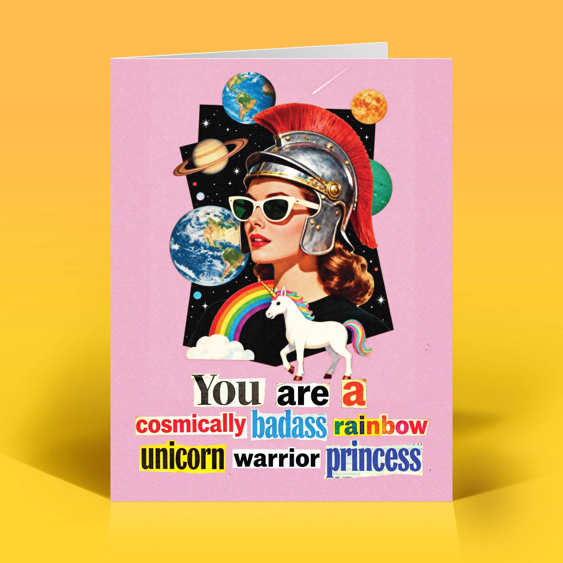 Card with a collage-style design of a woman in a warrior helmet with a unicorn, and planets on a pink background with texts that reads "You are a cosmically badass rainbow unicorn, warrior princess"