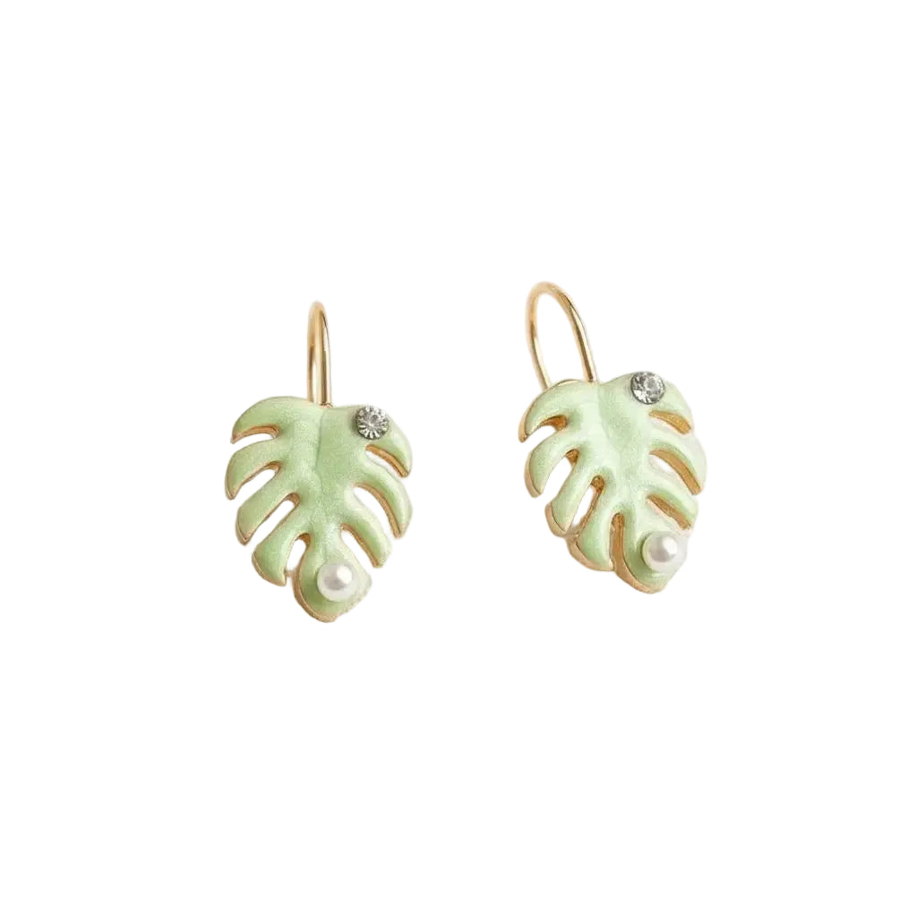 Pair of green monstera leaf-shaped earrings with a pearl and rhinestone detail on a white background