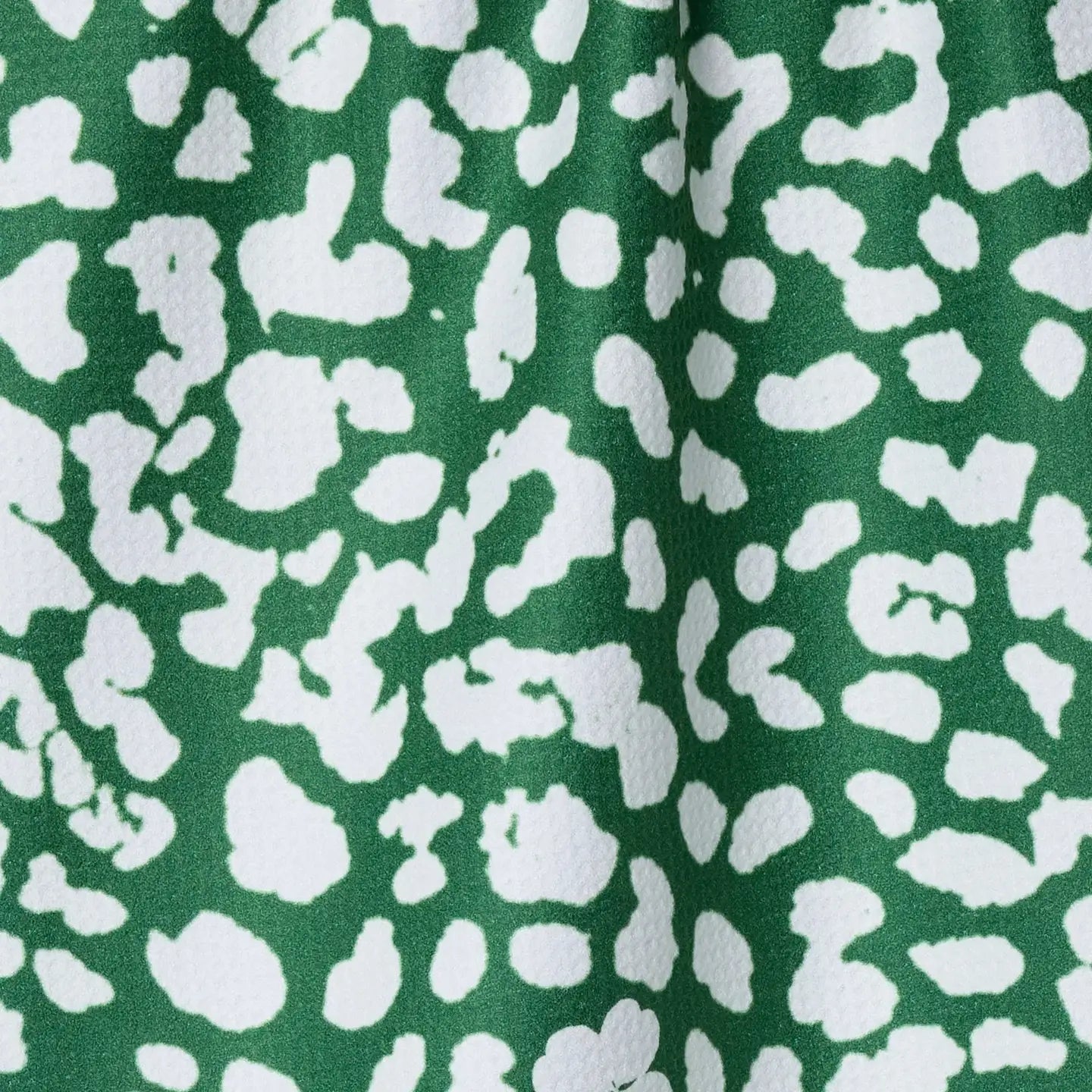 Green fabric with white abstract pattern