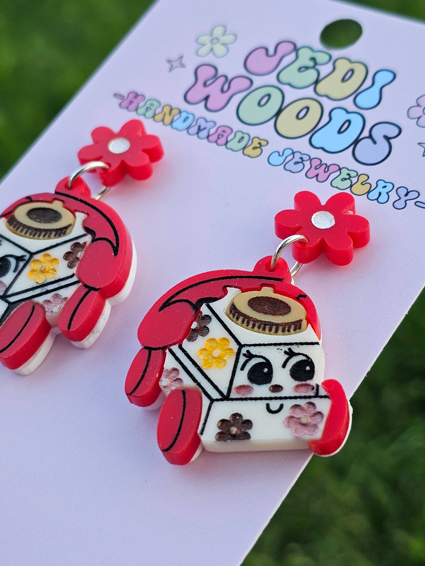 Colorful earrings resembling a cartoon phone on a 'Jedi Woods Handmade Jewelry' card.