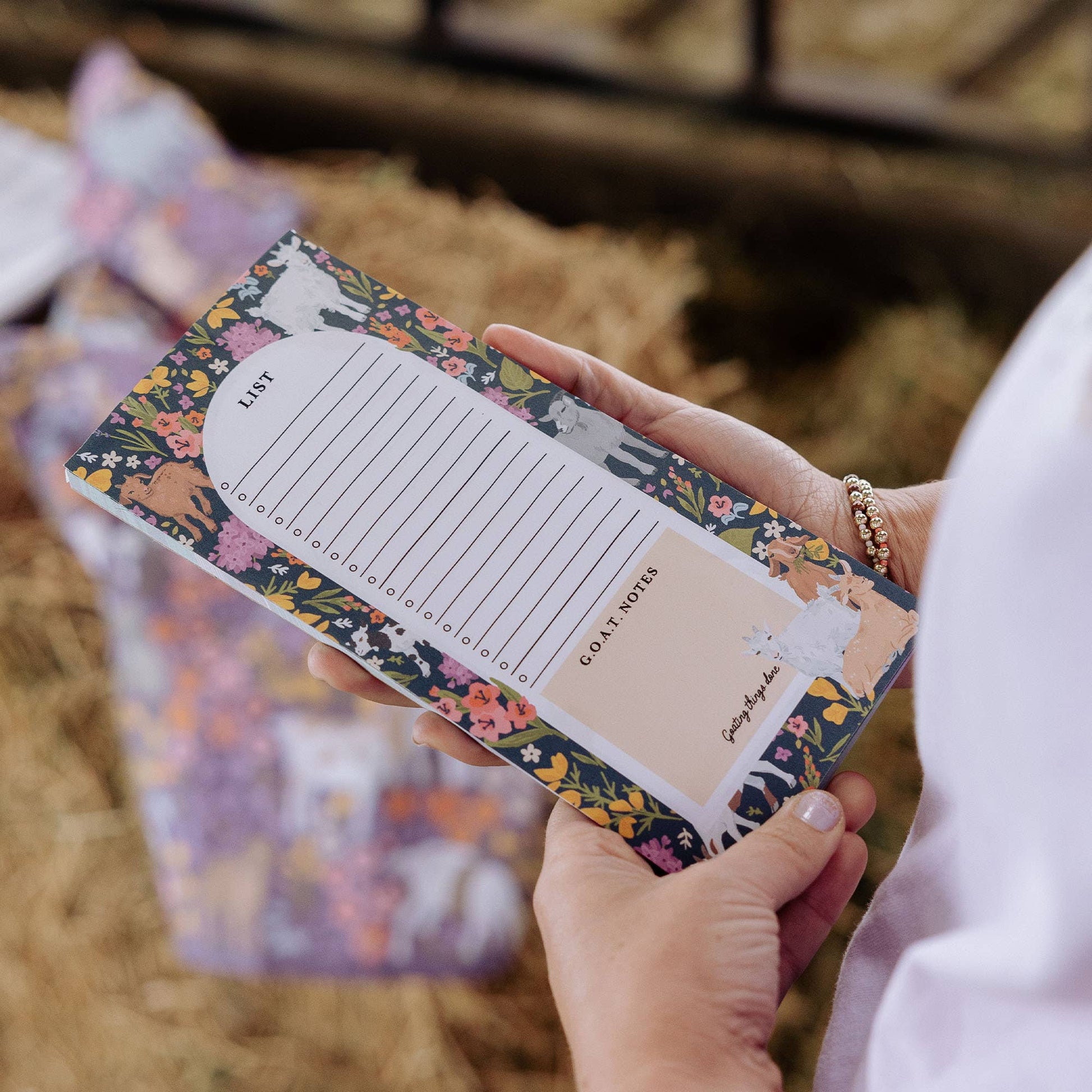 floral notebook held by hands