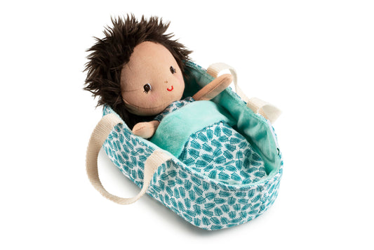 Plush doll in a teal patterned bag on a white background