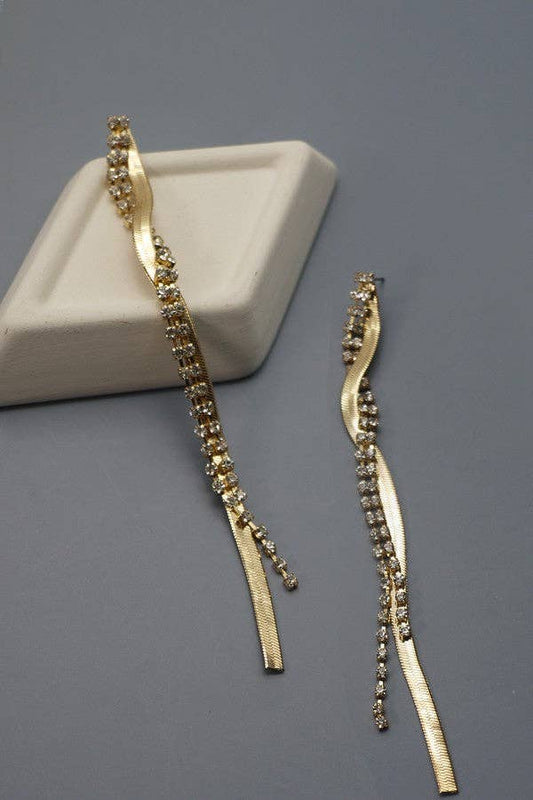 Gold twisted snakechain and rhinestone chain drop earrings on a grey background