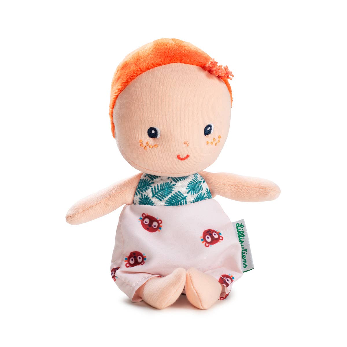 Plush toy with orange hair and ladybug pattern on a white background