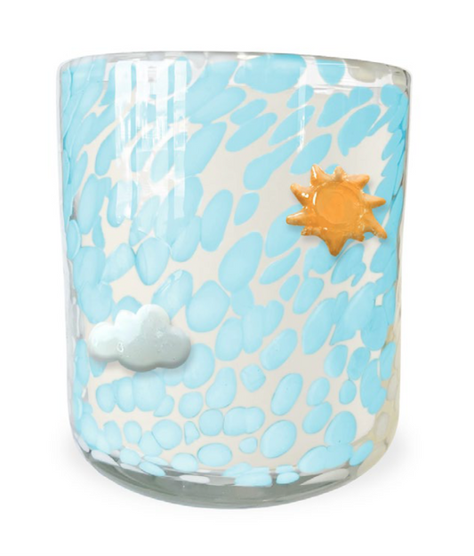 Glass tumbler with blue abstract design, sun, and cloud decorations on a white background