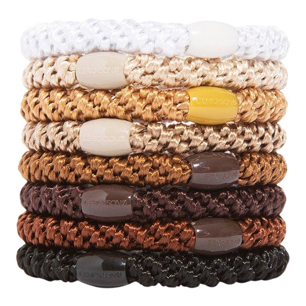 Stack of braided bracelets with colored beads on a white background