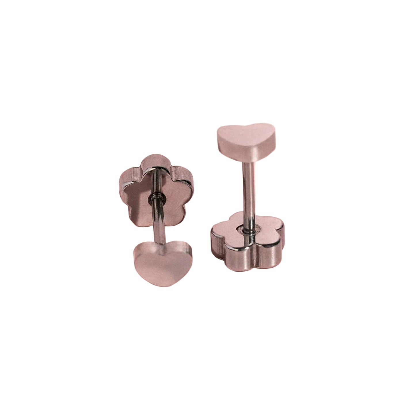 A pair of silver-toned heart stud earrings on a solid white background. The earrings feature a flower-shaped flat back 