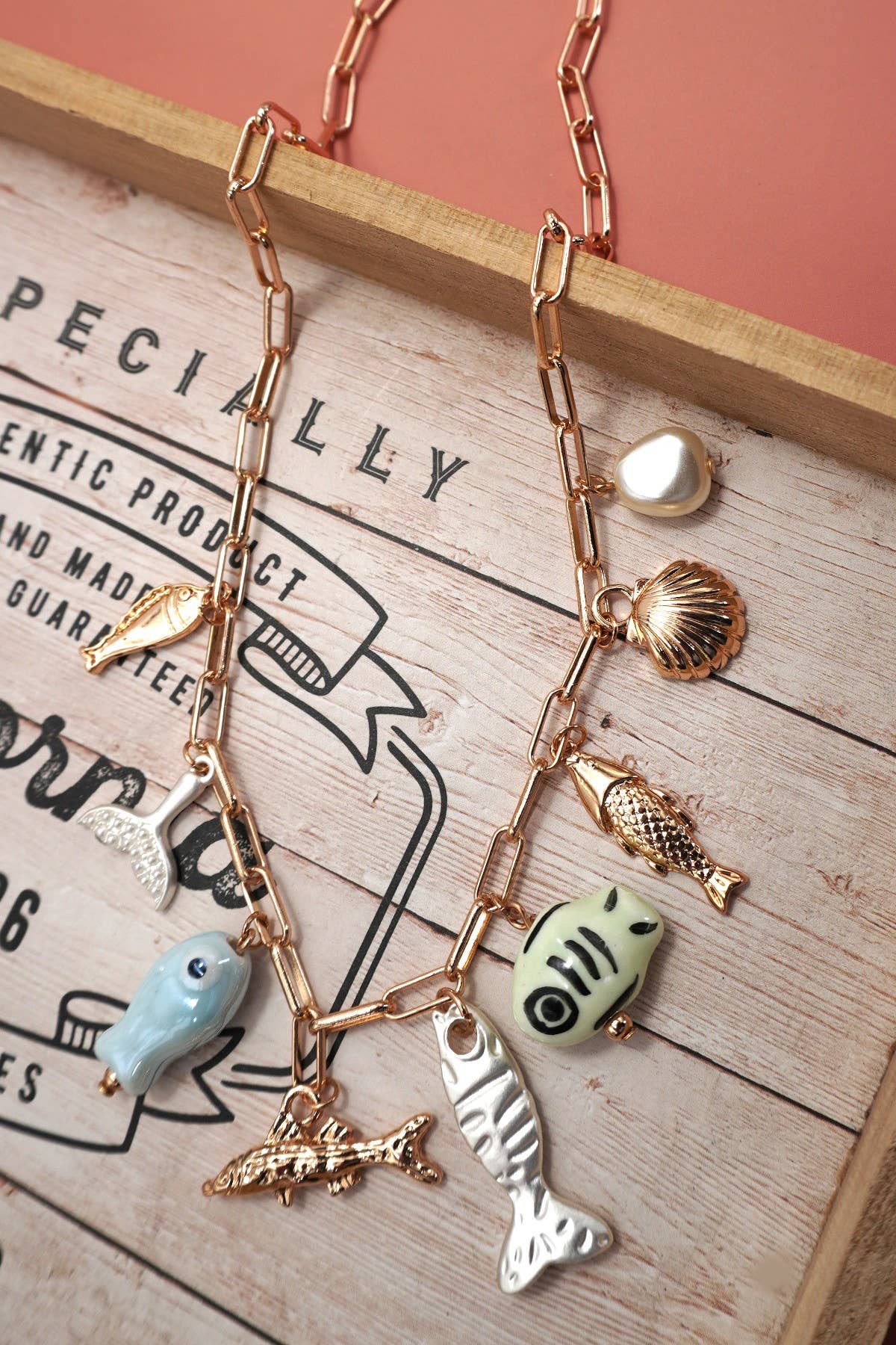 Necklace with various charms on a wooden board