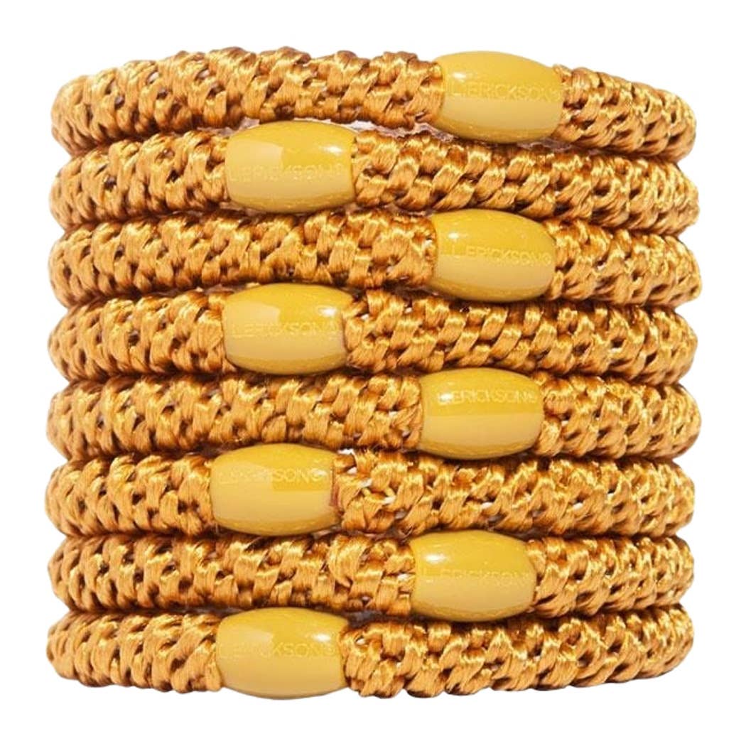 A stack of ten gold braided elastic stretch bracelets with matching oval yellow beads, shown on a plain white background.