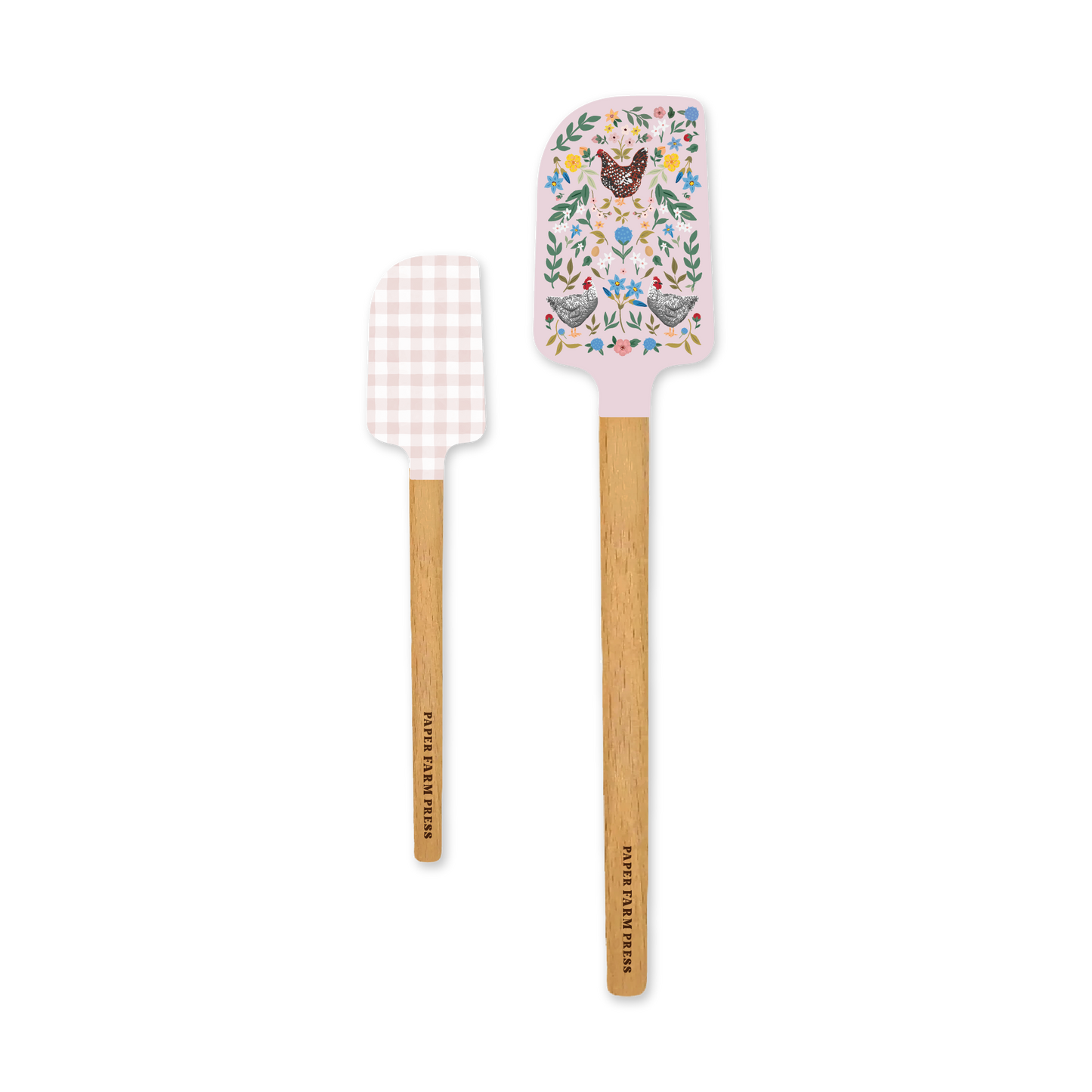 Two spatulas with decorative handles on a white background