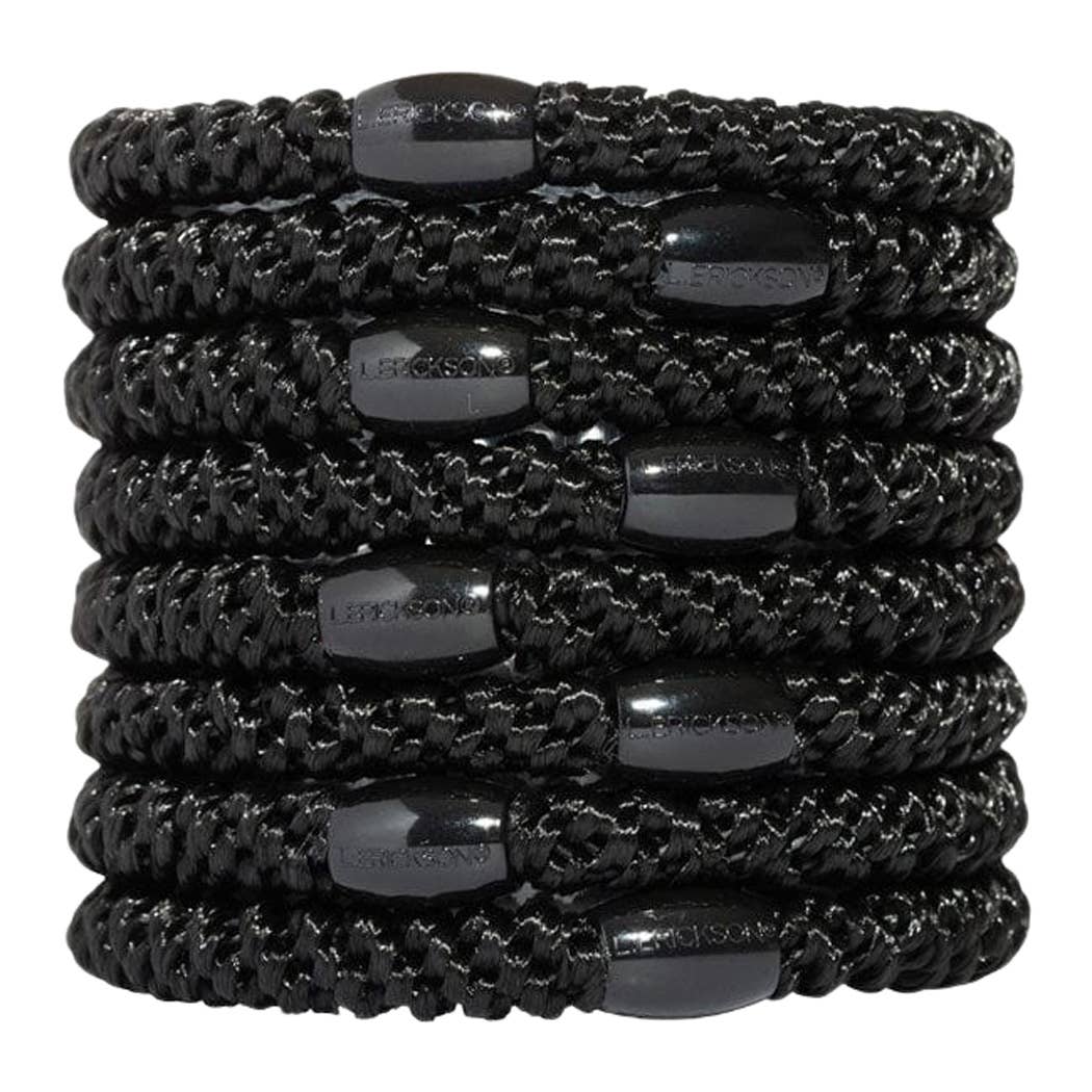 Stack of black hair ties with gray beads on a white background