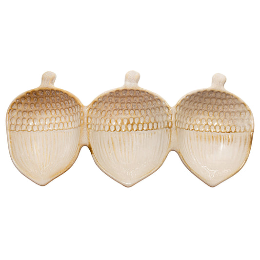 Three beige ceramic acorn-shaped holders on a white background