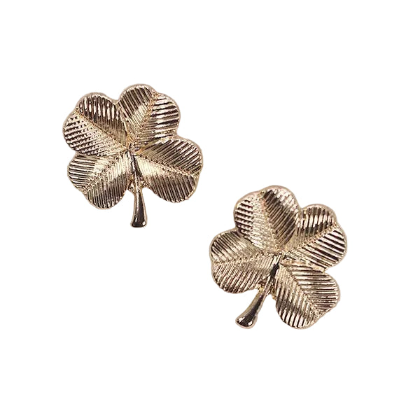 Two gold, four leaf clover shaped stud earrings on a white background