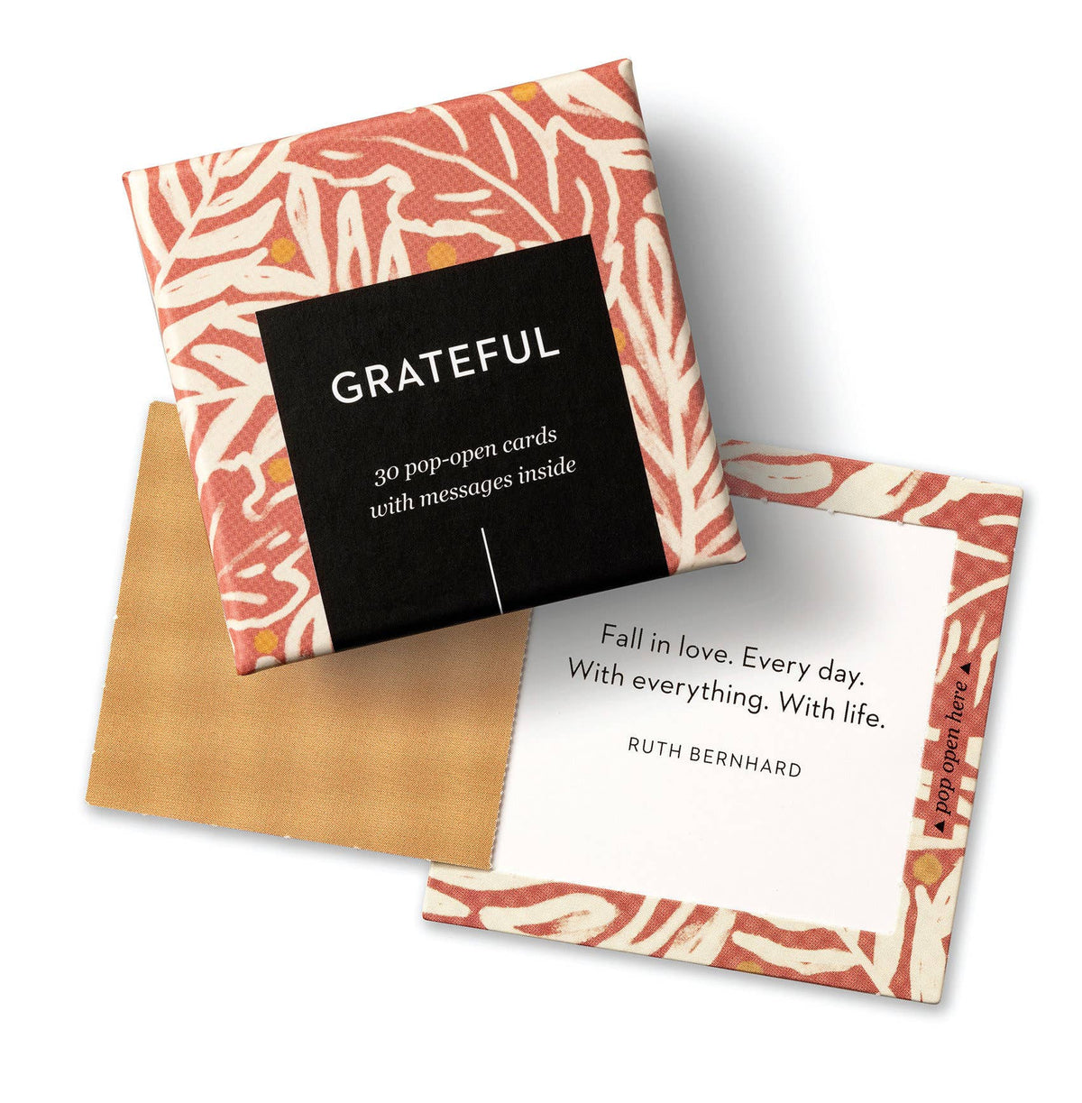 A box with the cover saying 'Grateful' and a card behind it saying 'Fall in love. Every day. With everything. With life. -Ruth Bernhard' all placed on a white background