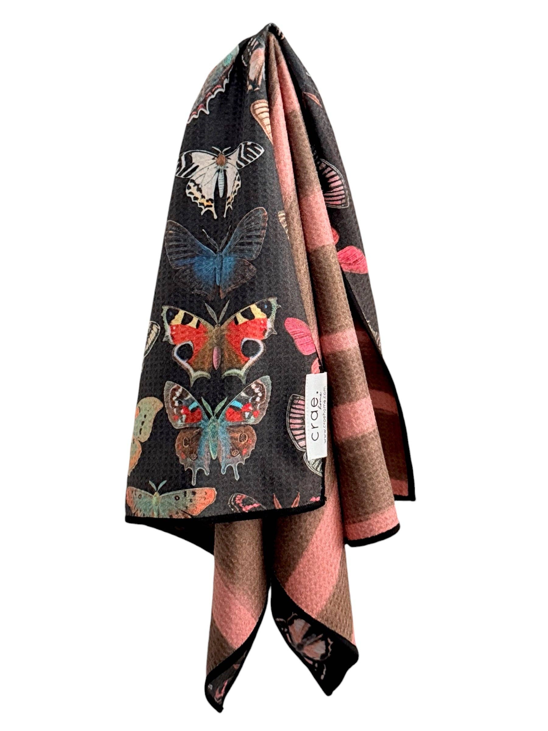 Colorful butterfly-patterned blanket on a white background