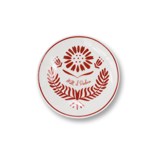 White butter pat with red floral design and text on a white background