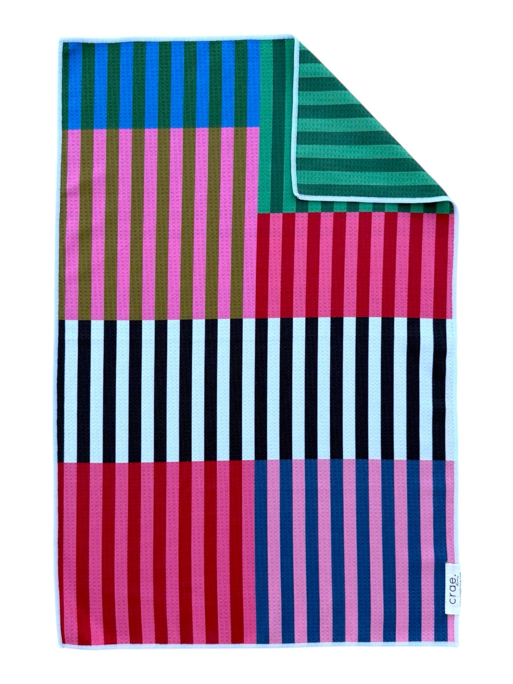 Colorful striped towel with geometric pattern on a white background
