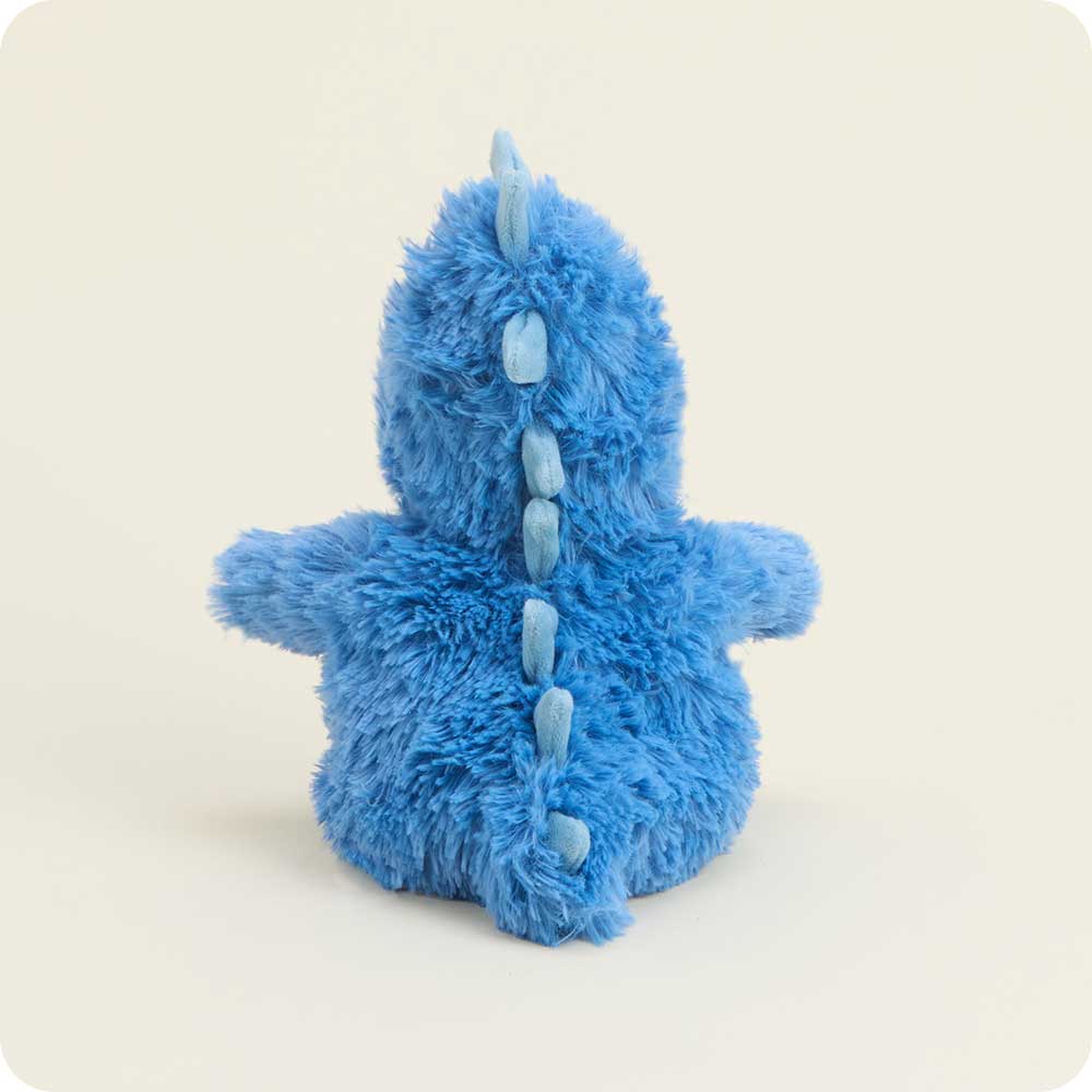 Blue plush toy with a dragon design on a light beige background