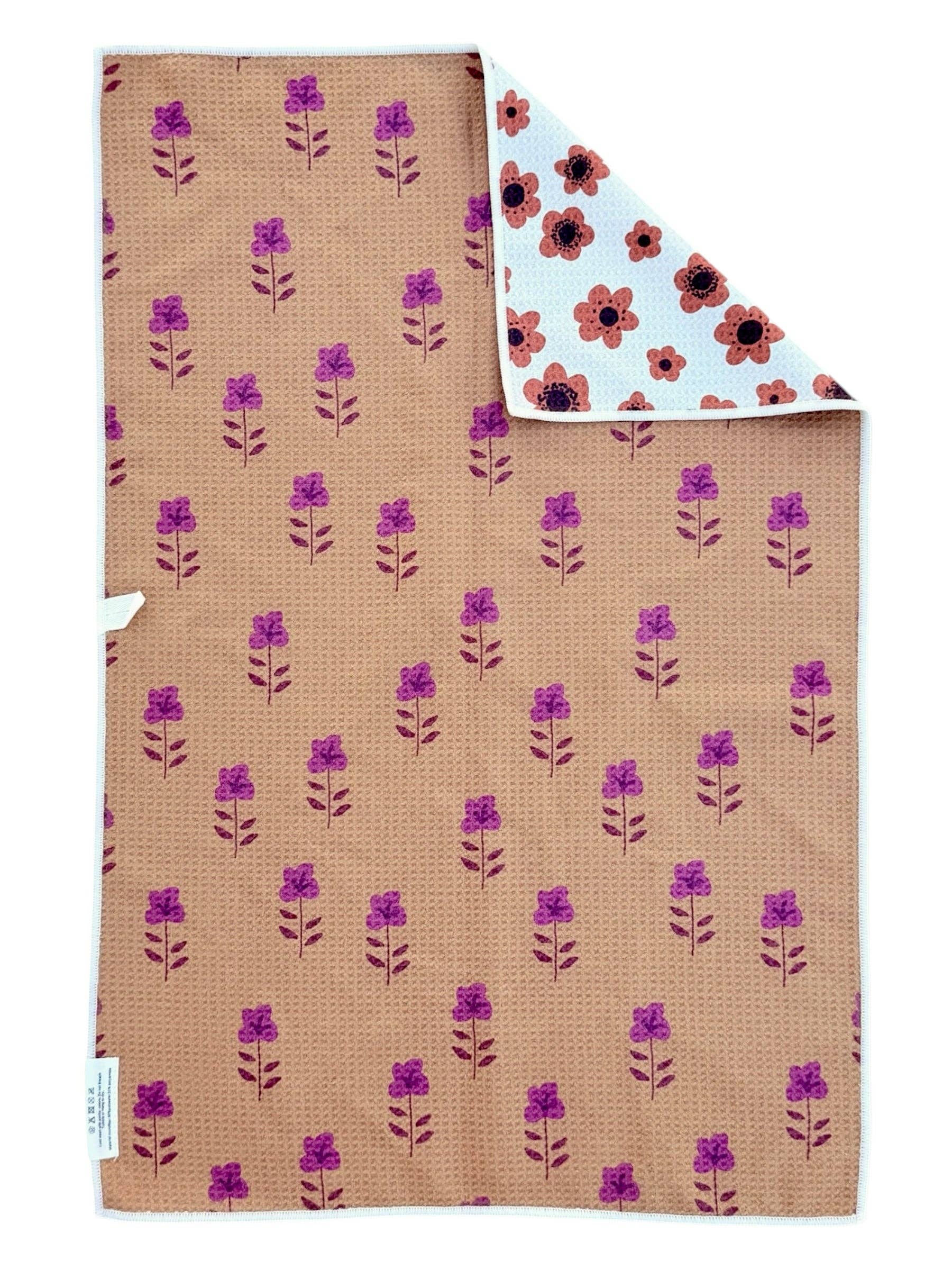 Floral-patterned fabric with purple flowers on a brown background