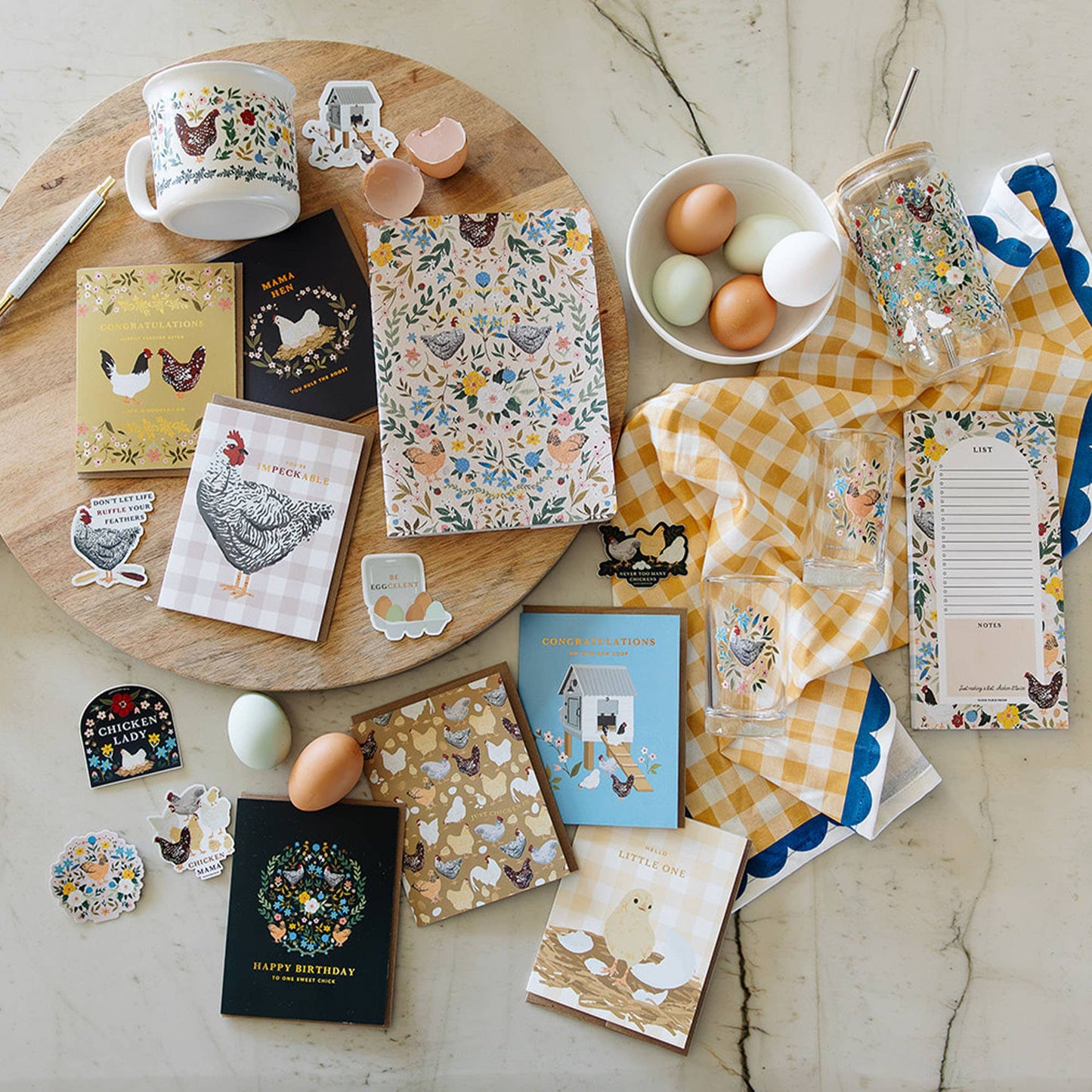 Collection of stationery items with farm-themed designs on a marble surface.