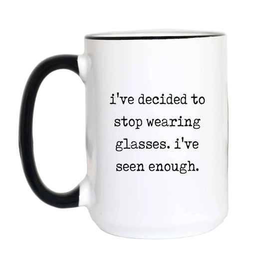 White mug with black handle and text 'i've decided to stop wearing glasses. i've seen enough.' on a white background