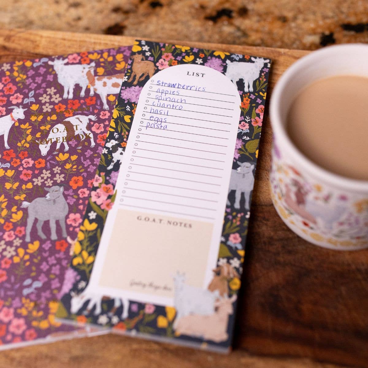Floral patterned notepad with a cup of coffee on a wooden surface