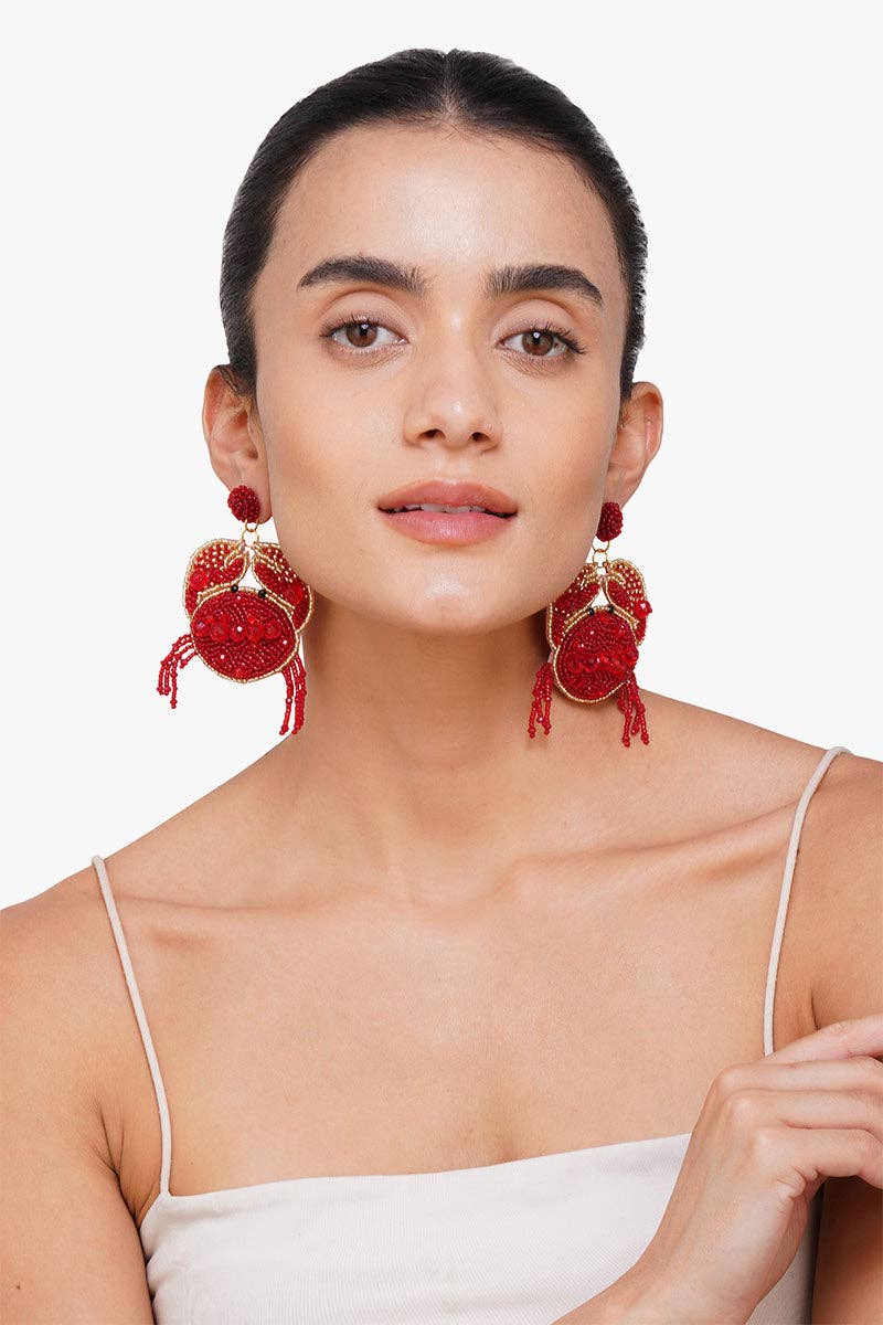 Woman wearing red earrings on a white background