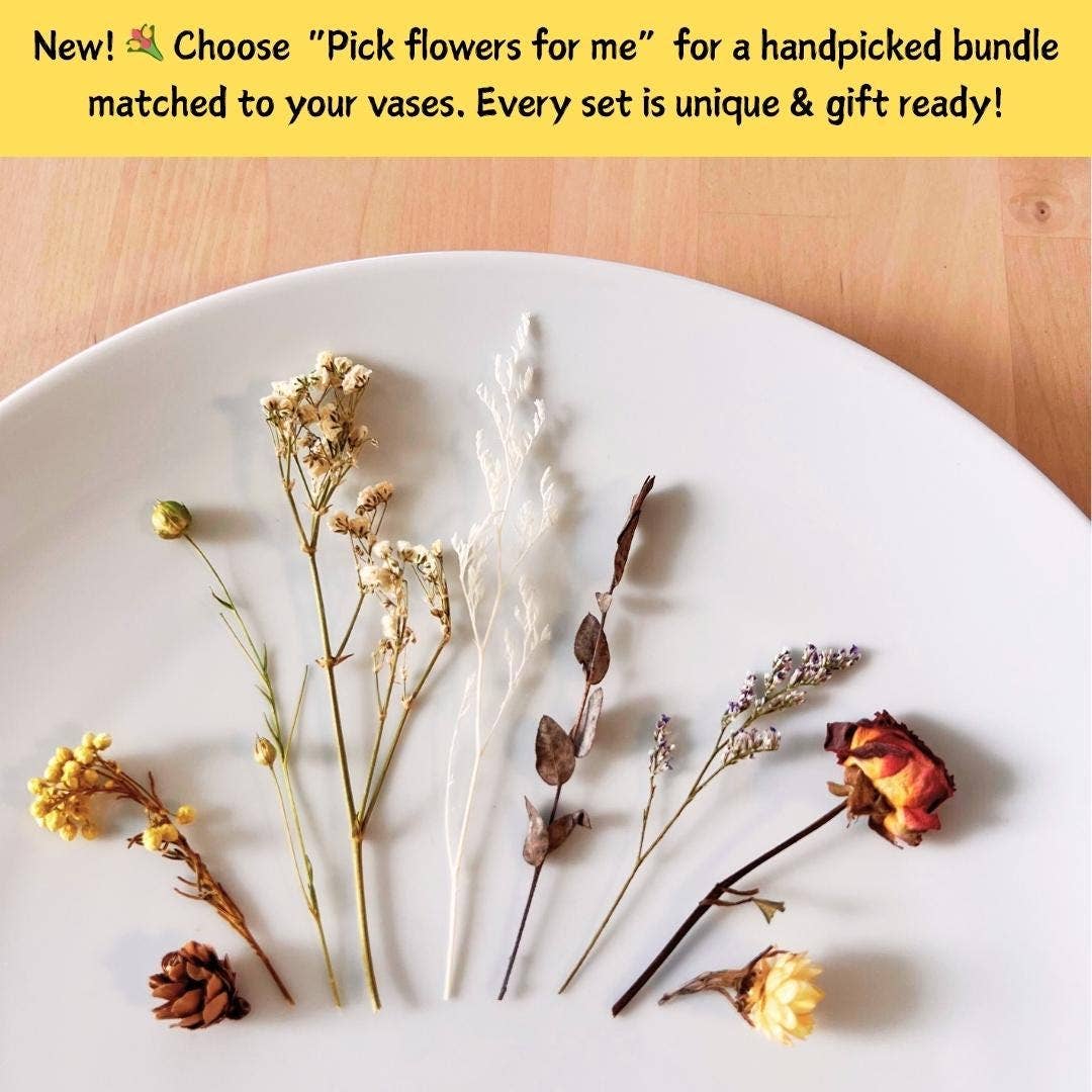 A selection of dried and fresh flowers arranged on a white plate, with a yellow promotional banner at the top describing a handpicked flower bundle matched to vases.