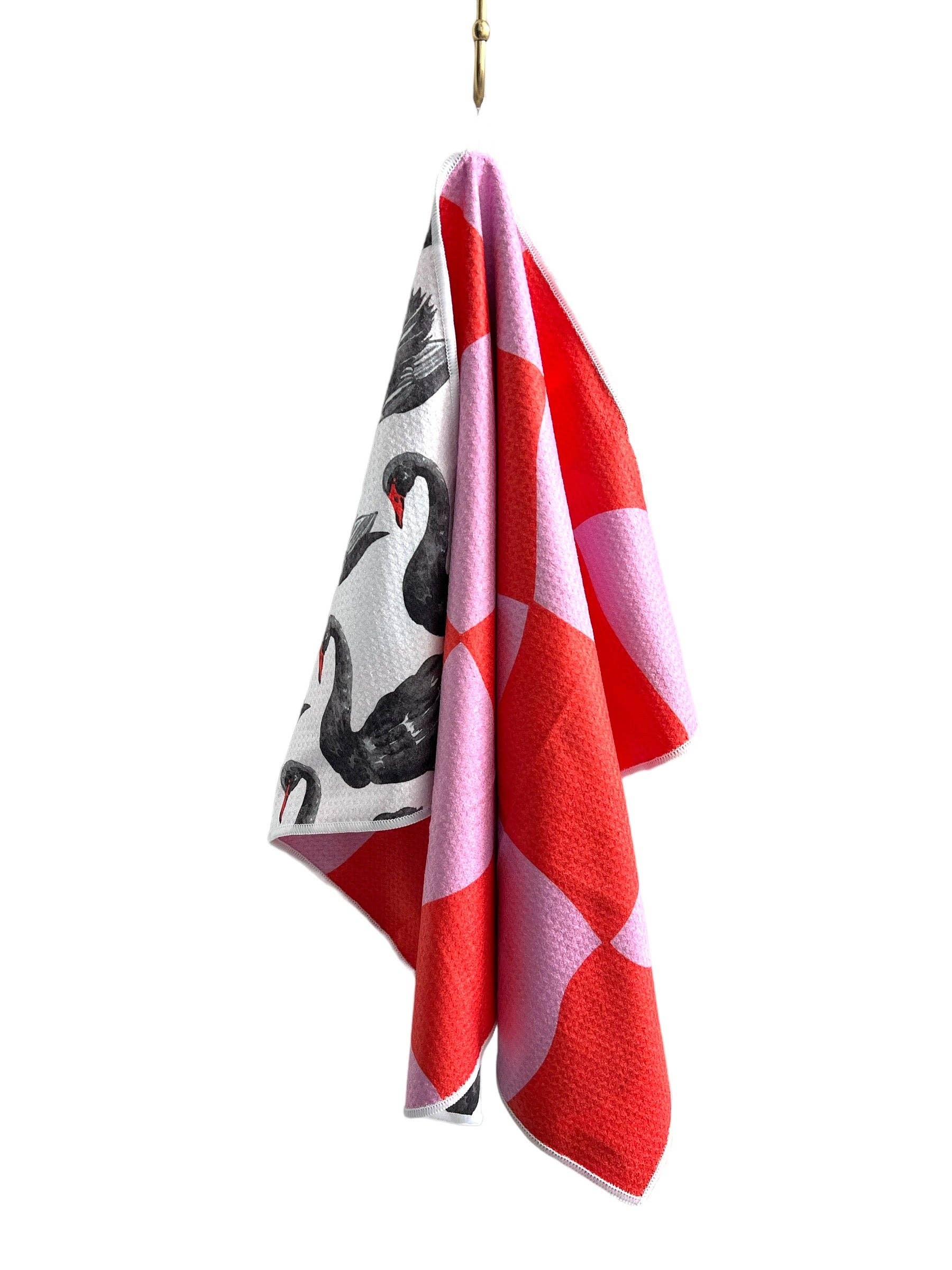 Colorful towel with abstract design hanging on a white background