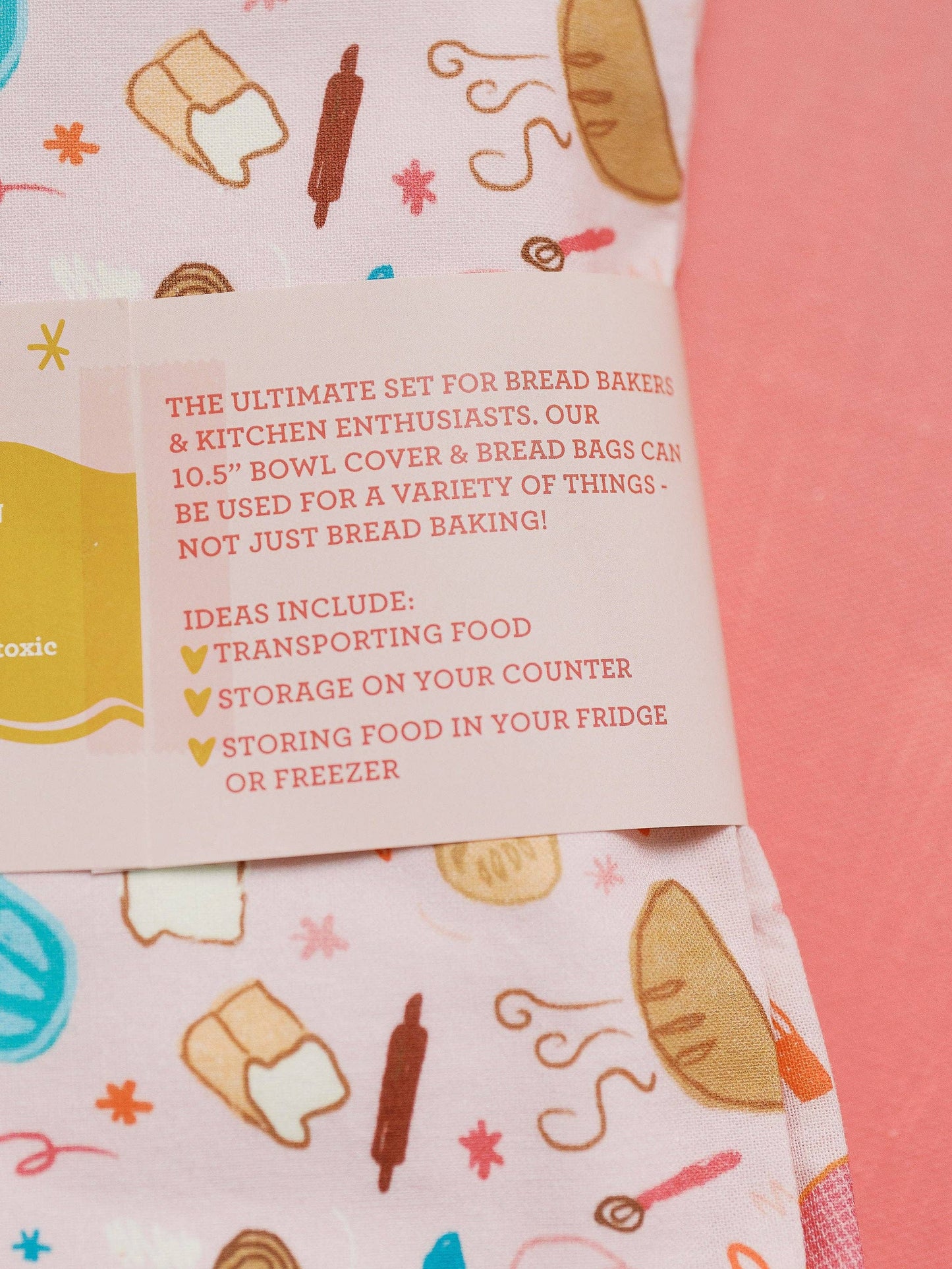 Bowl cover with bread-themed design and text on a pink background