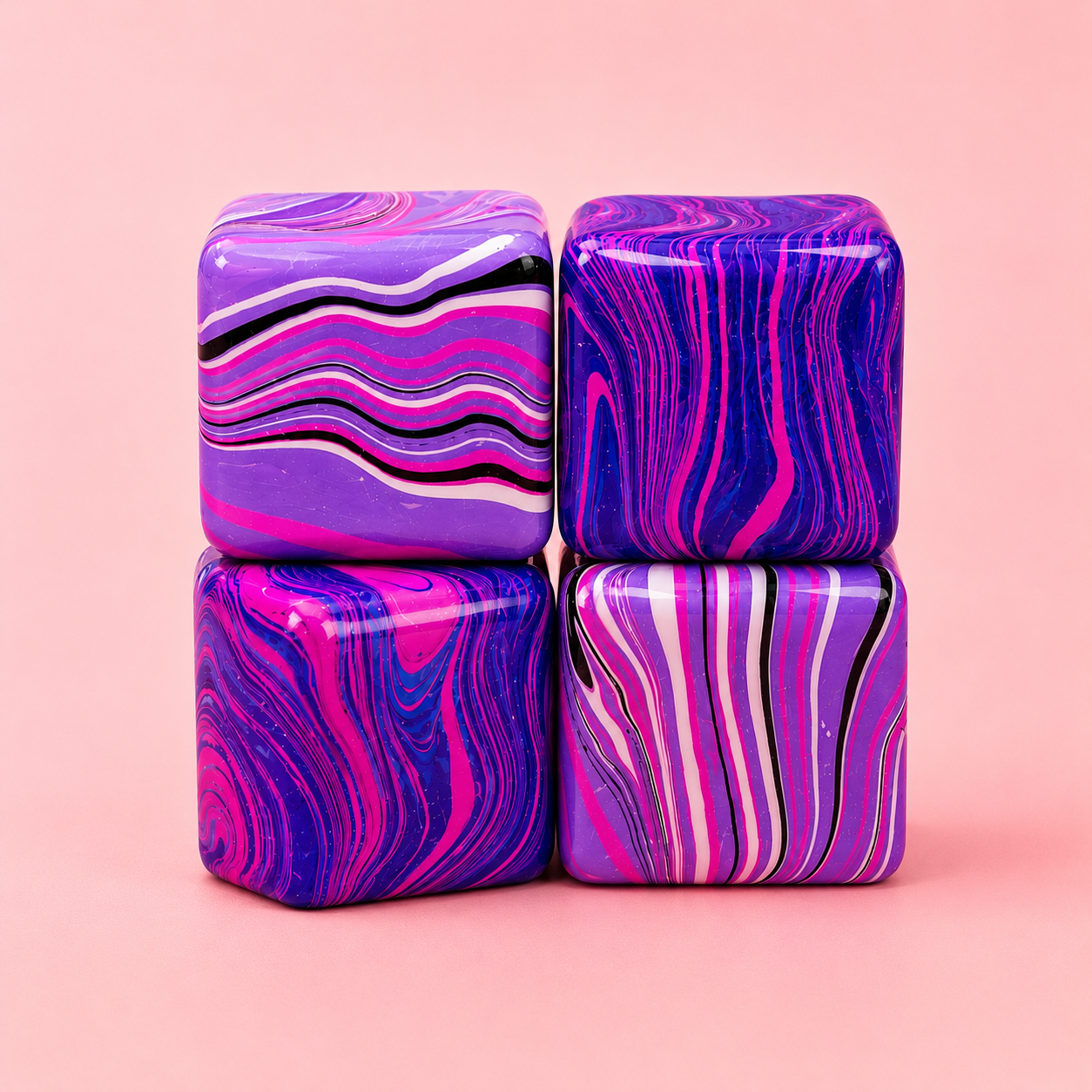 Four marbled cube-shaped objects with pink and purple patterns on a pink background