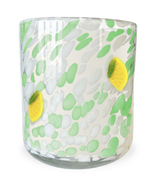 Glass tumbler with lemon pattern on a white background