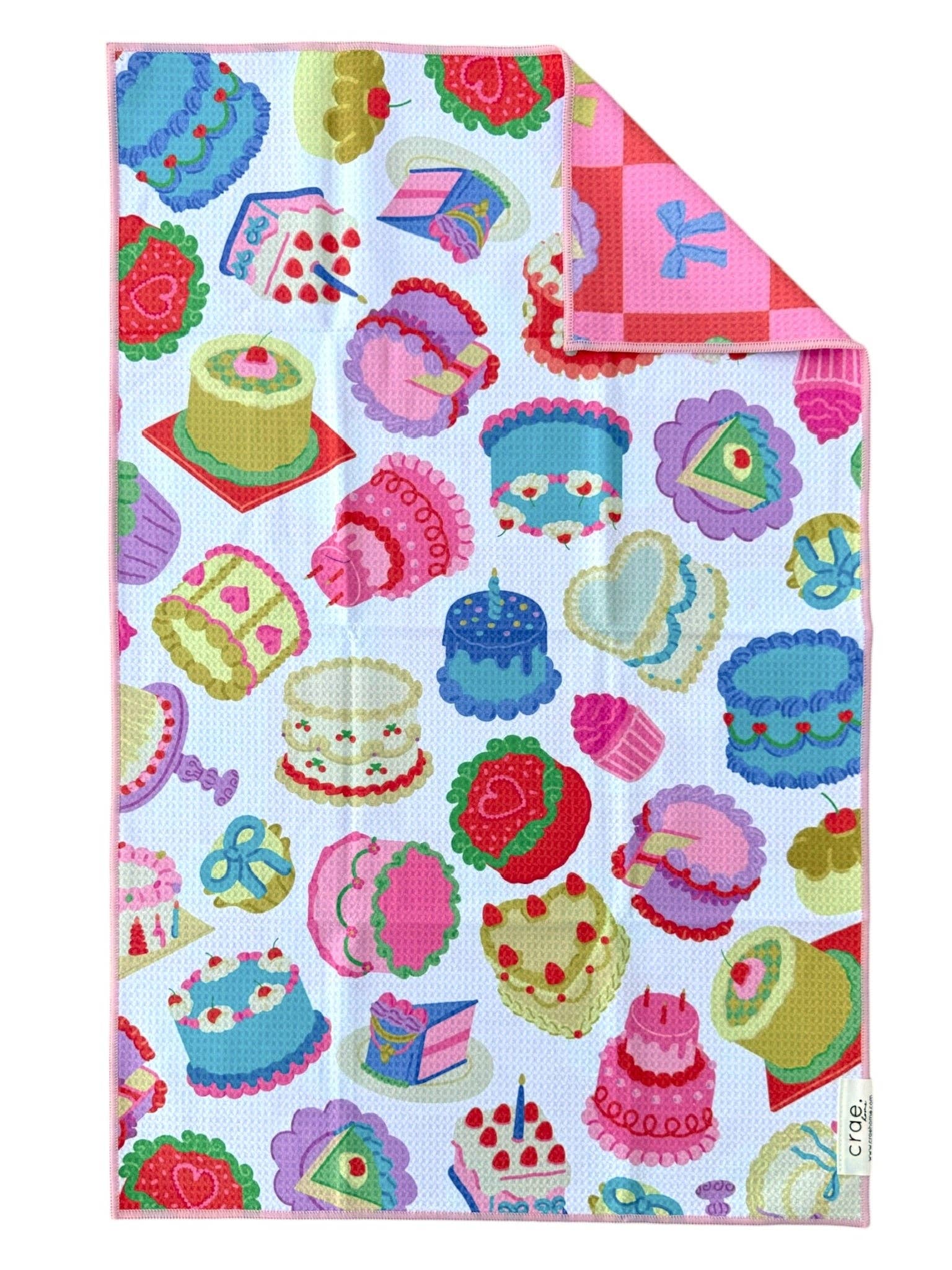 Colorful cake patterned fabric with a pink border on a white background