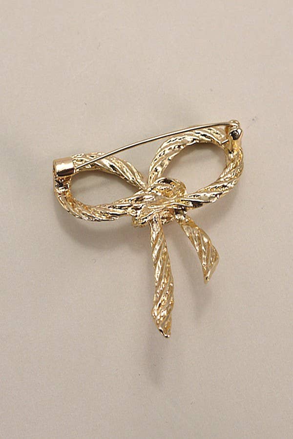Back of bow shaped brooch, showing horizontal pin